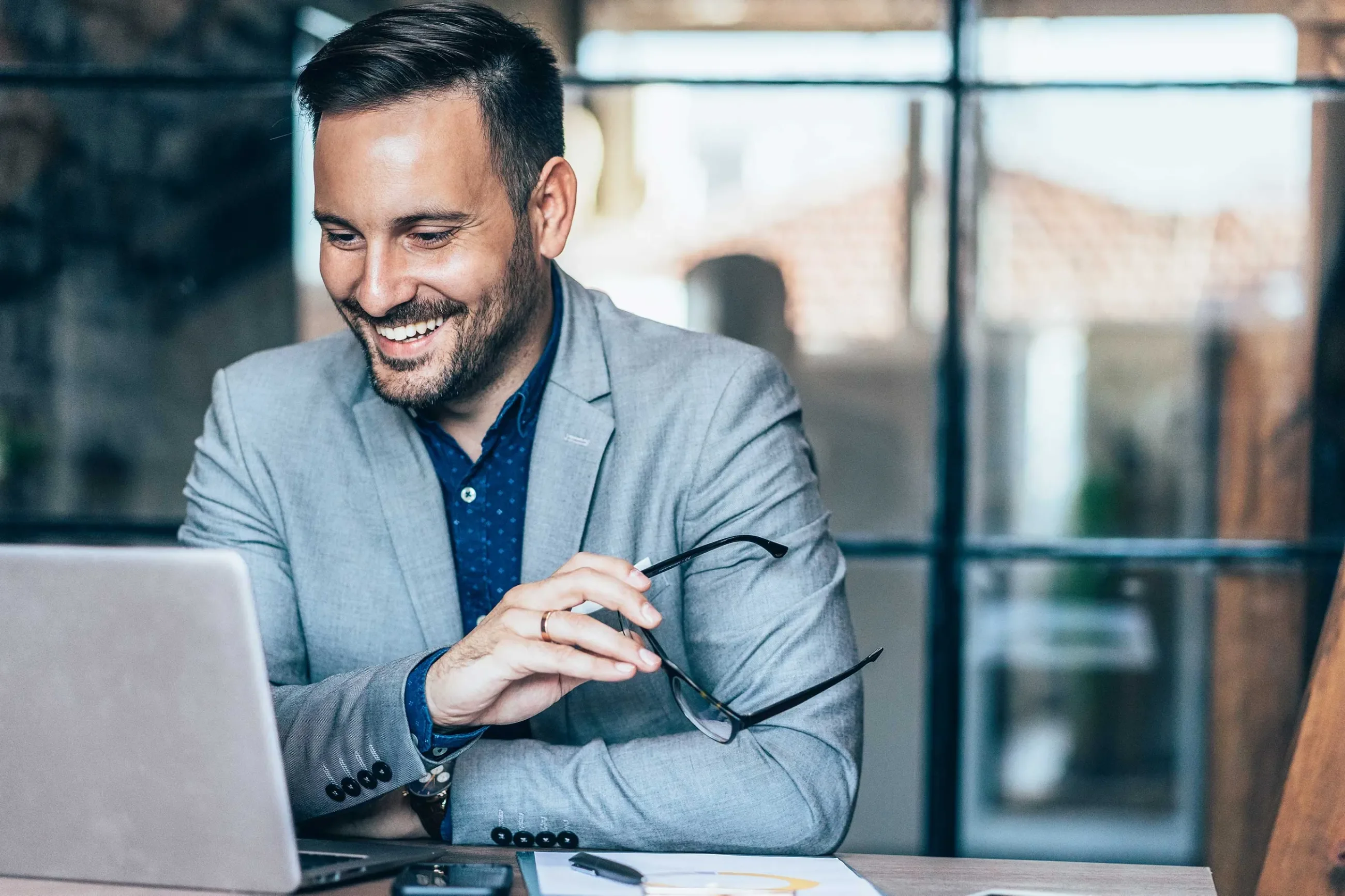 Businessman talking on a video call with a customer service representative smiling