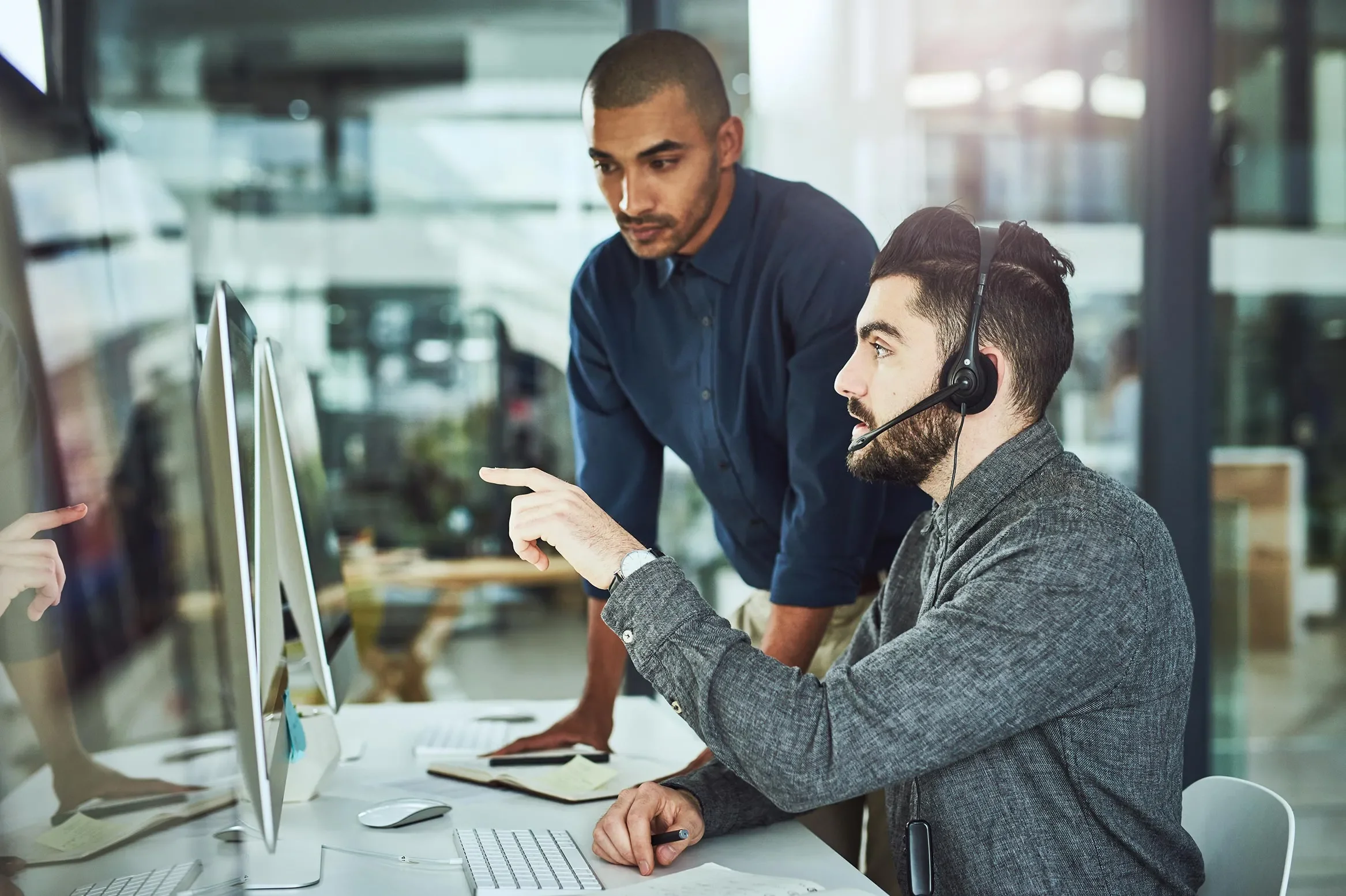 Call center manager overseeing a customer service employee