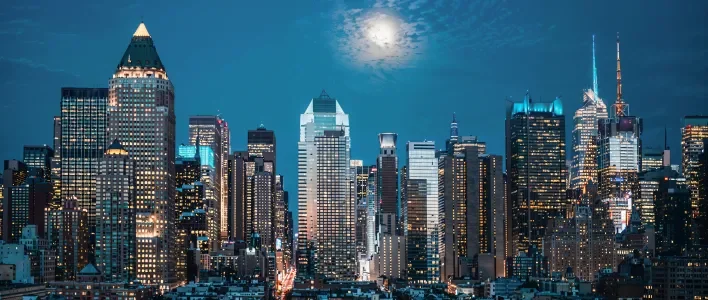 City skyline with moon overhead